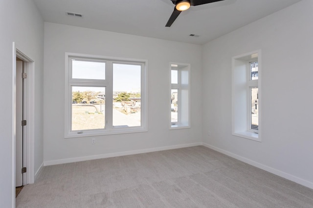 859 E 2nd St, Des Moines, IA 50309 - spare room featuring light carpet, ceiling fan, and visible vents