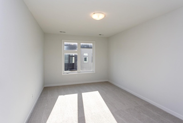 859 E 2nd St, Des Moines, IA 50309 - empty room with light colored carpet and baseboards