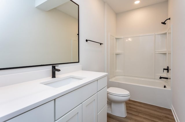 859 E 2nd St, Des Moines, IA 50309 - full bath featuring shower / washtub combination, vanity, recessed lighting, toilet, and wood finished floors
