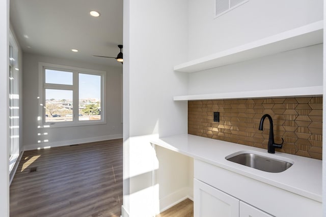 859 E 2nd St, Des Moines, IA 50309 - bar with tasteful backsplash, recessed lighting, wood finished floors, a sink, and baseboards
