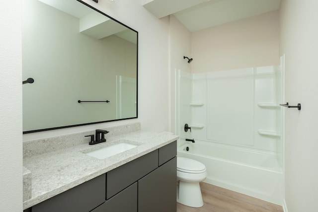 full bath featuring bathing tub / shower combination, vanity, toilet, and wood finished floors
