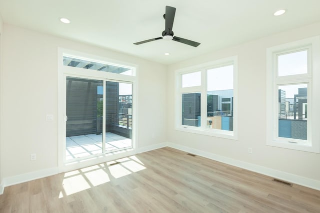 empty room with visible vents, ceiling fan, recessed lighting, and wood finished floors