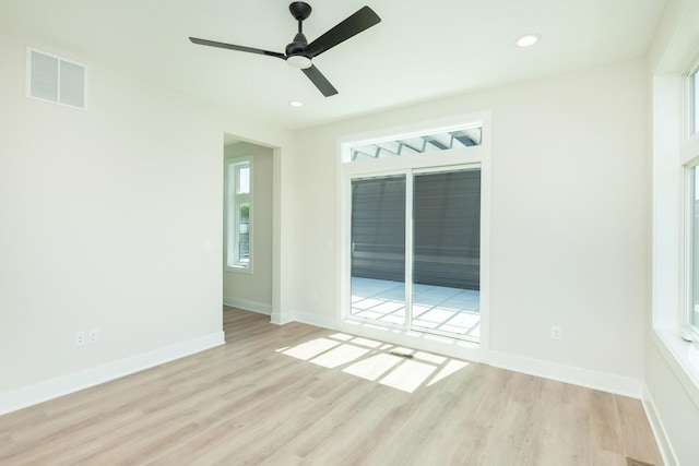 spare room featuring wood finished floors, baseboards, visible vents, and recessed lighting