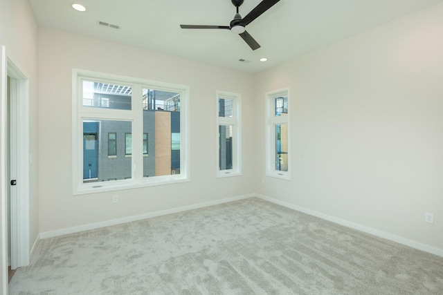empty room with visible vents, baseboards, a ceiling fan, carpet, and recessed lighting