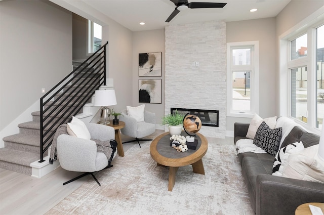 820 E 2nd St, Des Moines, IA 50309 - living area with a stone fireplace, recessed lighting, stairway, a ceiling fan, and wood finished floors