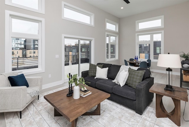 820 E 2nd St, Des Moines, IA 50309 - living room featuring a towering ceiling, baseboards, and recessed lighting