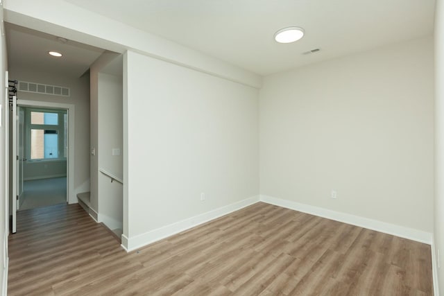822 E 2nd St, Des Moines, IA 50309 - spare room featuring light wood finished floors, baseboards, visible vents, and recessed lighting