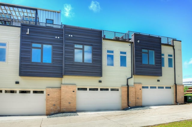 822 E 2nd St, Des Moines, IA 50309 - exterior space with brick siding and a garage