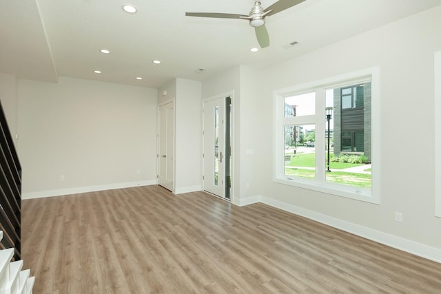 822 E 2nd St, Des Moines, IA 50309 - unfurnished living room featuring light wood-style flooring, baseboards, a ceiling fan, and recessed lighting