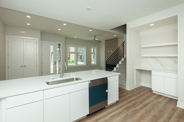 822 E 2nd St, Des Moines, IA 50309 - kitchen featuring recessed lighting, light wood-style flooring, backsplash, dishwashing machine, and a sink