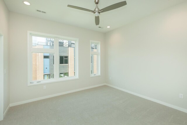 822 E 2nd St, Des Moines, IA 50309 - unfurnished room featuring visible vents, baseboards, recessed lighting, and light colored carpet