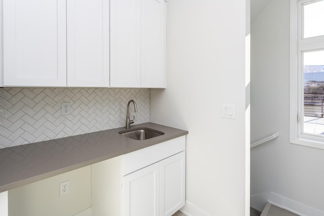 laundry area featuring a sink and baseboards