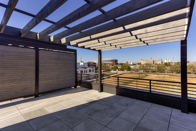 view of patio / terrace featuring a pergola and a city view