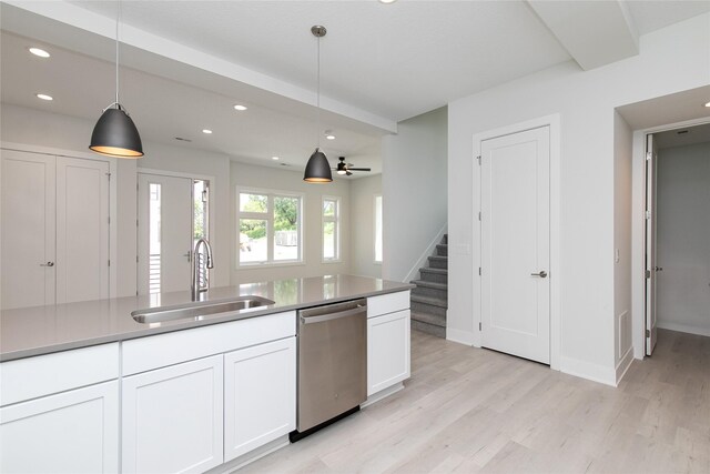 225 Maple St, Des Moines, IA 50309 - kitchen featuring light wood-type flooring, white cabinets, dishwasher, a sink, and decorative light fixtures