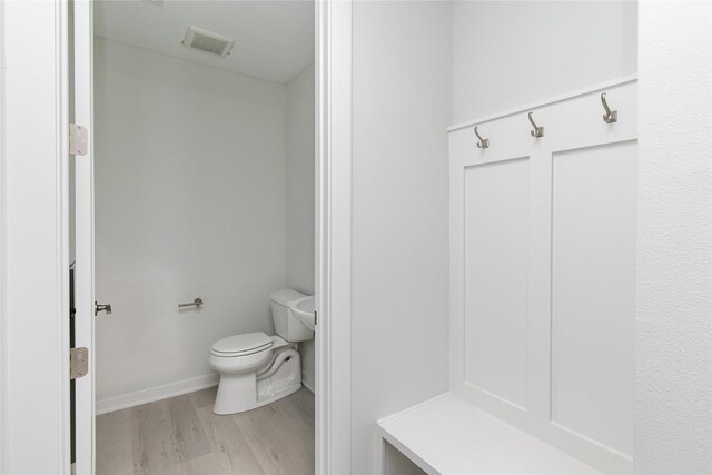 225 Maple St, Des Moines, IA 50309 - bathroom featuring visible vents, baseboards, toilet, and wood finished floors