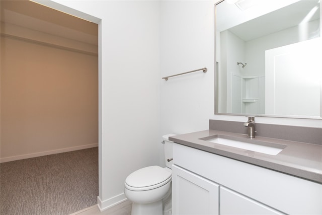 225 Maple St, Des Moines, IA 50309 - bathroom featuring toilet, vanity, baseboards, and walk in shower