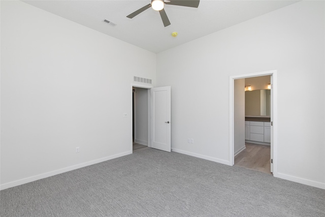 225 Maple St, Des Moines, IA 50309 - unfurnished bedroom featuring visible vents, baseboards, carpet flooring, and a towering ceiling