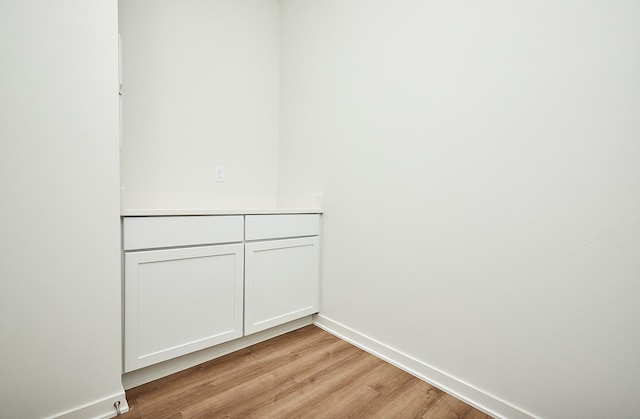 interior space featuring wood finished floors and baseboards