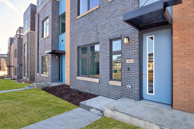 property entrance with brick siding
