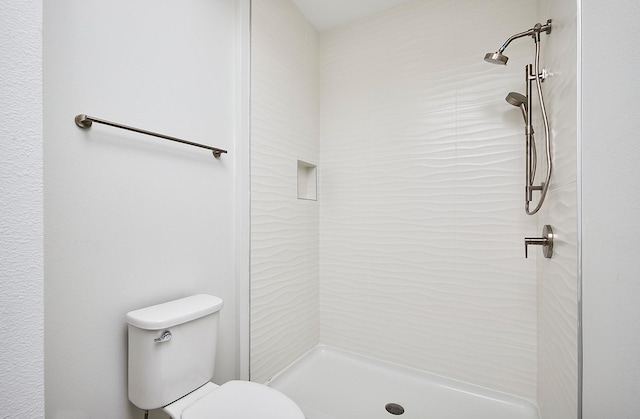 full bath featuring toilet and a stall shower