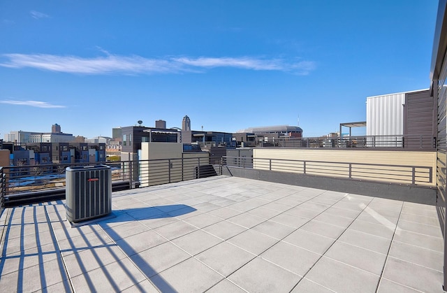 view of patio / terrace with cooling unit and a view of city