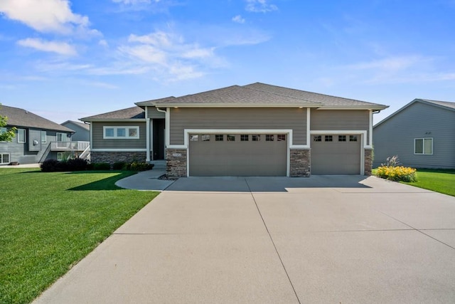 2102 NW 24th St, Ankeny, IA 50023 - prairie-style house with stone siding, an attached garage, concrete driveway, and a front lawn