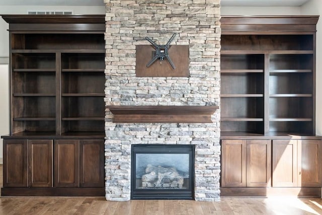 2102 NW 24th St, Ankeny, IA 50023 - unfurnished living room with wood finished floors and a stone fireplace