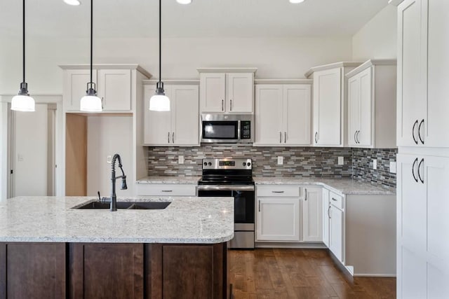 2102 NW 24th St, Ankeny, IA 50023 - kitchen featuring appliances with stainless steel finishes, white cabinetry, dark wood-type flooring, decorative backsplash, and recessed lighting