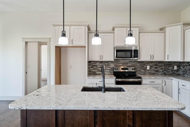 2102 NW 24th St, Ankeny, IA 50023 - kitchen featuring stainless steel appliances, decorative backsplash, and dark wood finished floors