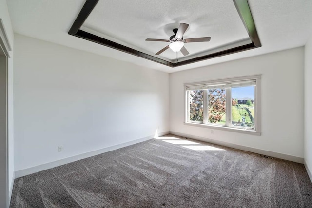 2102 NW 24th St, Ankeny, IA 50023 - empty room with a tray ceiling, carpet floors, and a ceiling fan