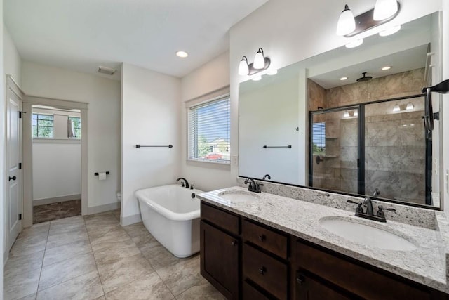 2102 NW 24th St, Ankeny, IA 50023 - bathroom featuring healthy amount of natural light, a shower stall, a freestanding bath, and double vanity