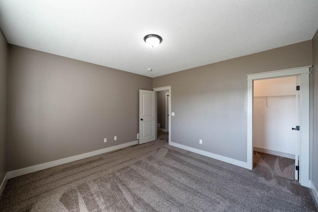 2102 NW 24th St, Ankeny, IA 50023 - unfurnished bedroom featuring carpet, a spacious closet, and a closet