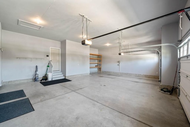 2102 NW 24th St, Ankeny, IA 50023 - garage with a garage door opener and baseboards