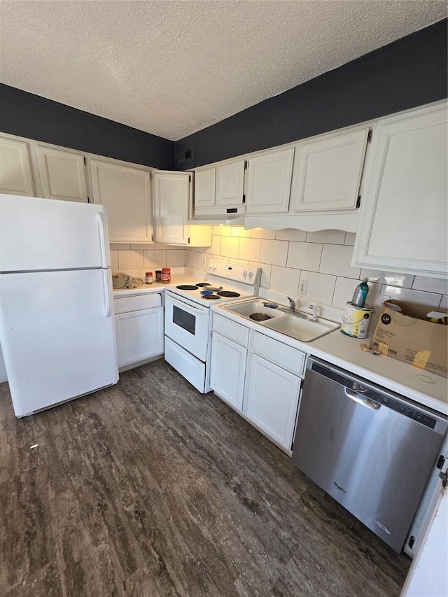 kitchen with white appliances, a textured ceiling, white cabinets, dark wood-style flooring, and light countertops