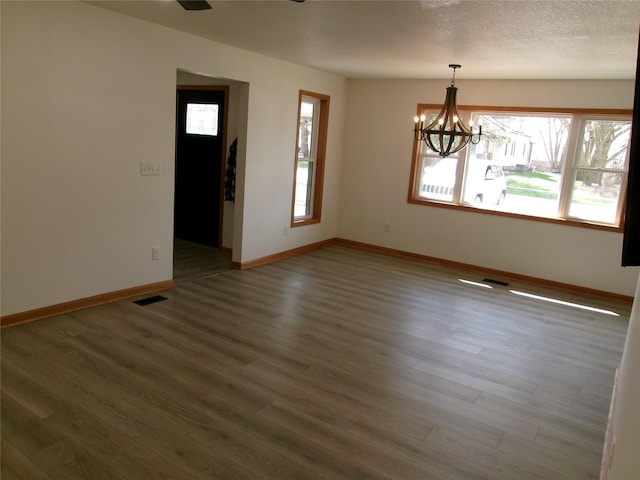 408 5th St, Menlo, IA 50164 - spare room featuring a chandelier, wood finished floors, and baseboards