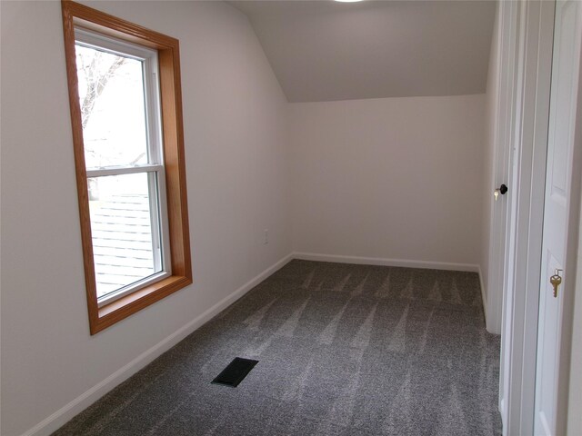 408 5th St, Menlo, IA 50164 - bonus room with dark carpet, vaulted ceiling, healthy amount of natural light, and baseboards