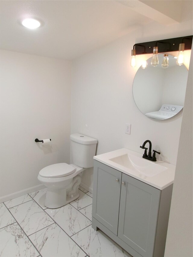 408 5th St, Menlo, IA 50164 - half bathroom with vanity, toilet, baseboards, and marble look tile flooring