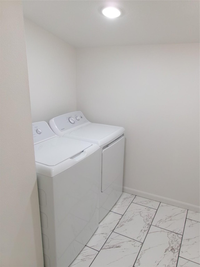 408 5th St, Menlo, IA 50164 - laundry area featuring washing machine and dryer, light marble finish flooring, and baseboards