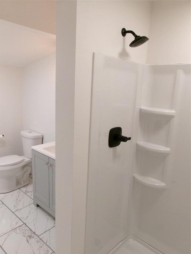 408 5th St, Menlo, IA 50164 - full bath featuring a stall shower, vanity, marble look tiles, and toilet