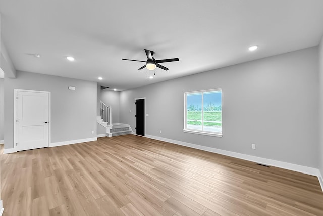 320 Veterans Blvd, Knoxville, IA 50138 - unfurnished room featuring ceiling fan, stairway, light wood-style flooring, and recessed lighting