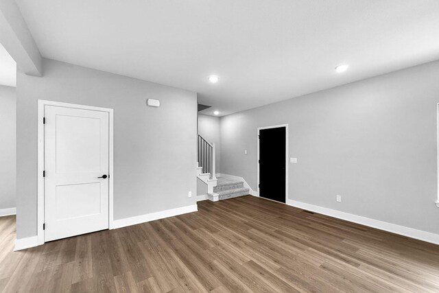 320 Veterans Blvd, Knoxville, IA 50138 - spare room with wood finished floors, stairway, and recessed lighting