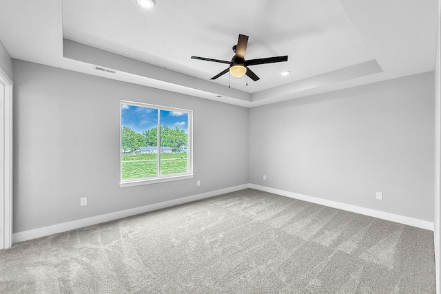 320 Veterans Blvd, Knoxville, IA 50138 - unfurnished room featuring a tray ceiling, a ceiling fan, carpet, and recessed lighting
