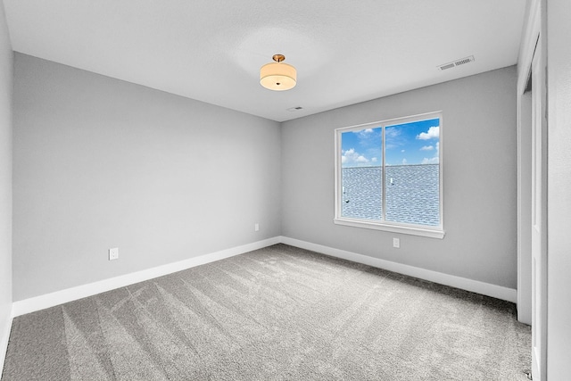 320 Veterans Blvd, Knoxville, IA 50138 - empty room featuring baseboards and carpet