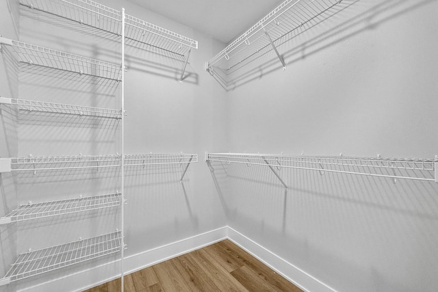 324 Veterans Blvd, Knoxville, IA 50138 - spacious closet featuring wood finished floors