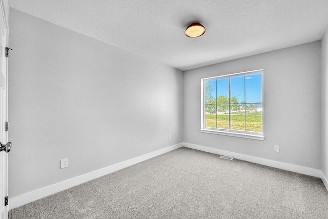 324 Veterans Blvd, Knoxville, IA 50138 - carpeted empty room featuring a textured ceiling