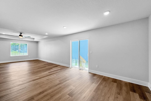 324 Veterans Blvd, Knoxville, IA 50138 - empty room with wood finished floors, a ceiling fan, and recessed lighting