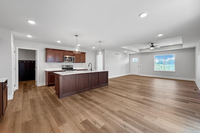 324 Veterans Blvd, Knoxville, IA 50138 - kitchen with appliances with stainless steel finishes, light countertops, light wood-style floors, recessed lighting, and a ceiling fan