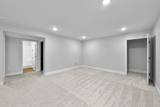 324 Veterans Blvd, Knoxville, IA 50138 - basement with recessed lighting and light colored carpet