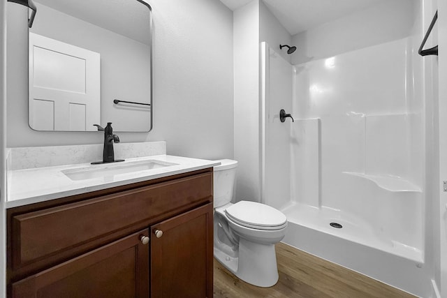 324 Veterans Blvd, Knoxville, IA 50138 - bathroom featuring vanity, wood finished floors, and a shower