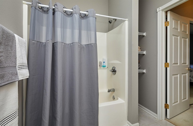 1325 SE Florence Dr Unit 211, Waukee, IA 50263 - bathroom with tile patterned floors, shower / bath combo with shower curtain, and baseboards